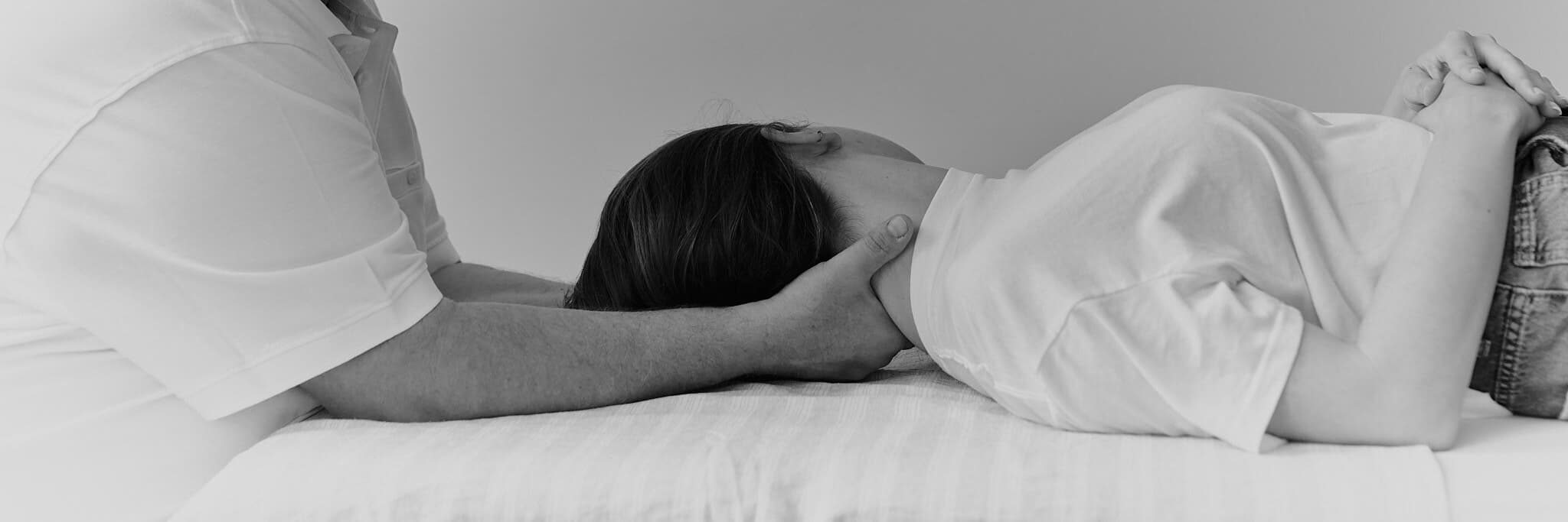 Behandlung von liegender Patientin im Nacken